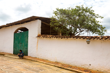 BARICHARA, COLOMBIA - MAY 5: An unidentified man sits on the sidewalk in Barichara Colombia on May 5, 2016.のeditorial素材