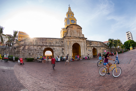 CARTAGENA, COLOMBIA - MAY 22: Unidentified tourists ride bikes at the plaza in front of the clocktower gate in Cartagena, Colombia on May 22, 2016.のeditorial素材