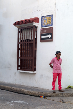 CARTAGENA, COLOMBIA - MAY 20: An unidentified man dressed in pink stands on a street corner in the old part of Cartagena, Colombia on May 20, 2016.のeditorial素材