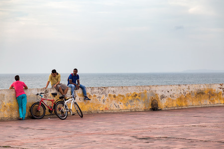 CARTAGENA, COLOMBIA - MAY 24: Unidentified men withtheir bikes relax on the colonial wall around Cartagena, Colombia on May 24, 2016.のeditorial素材