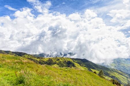 A green valley with dramatic clouds near Tolima, Colombia.の写真素材