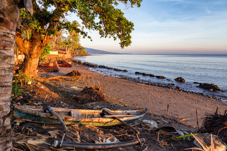 Morning light hits a traditional boat on a beach in Maumere on the island of East Nusa Tenggara in...