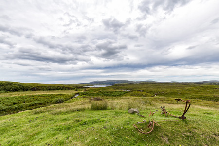 Old metal parts next to the Brunigilburn river and Loch Erghallan on the Isle of Skye in Scotland.の写真素材