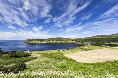 Fields and the port town of Uig on a summer morning on the Isle of Skye in Scotland.の写真素材