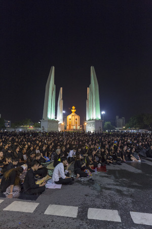 BANGKOK, THAILAND - OCTOBER 26: Unidentified mourners in black sit and watch the royal activities for the cremation of Rama 9, the former king next to Democracy Monument in Bangkok, Thailand on October 26, 2017.のeditorial素材