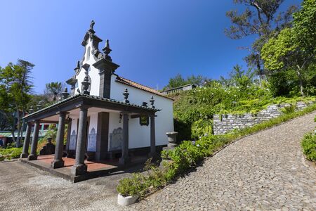 The Sancta Maria Chapel surrounded by intricate cobblestone pathways near the Jardim Tropical Monte Palace in Funchal.の写真素材