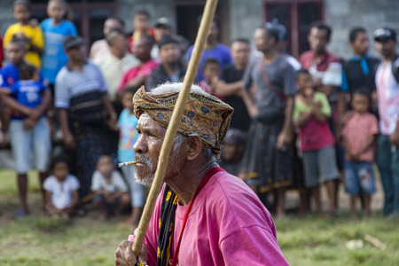 BAJAWA, INDONESIA - MAY 19: An unidentified elder performs traditional dancing at a boxing match...