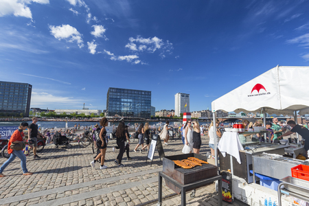 COPENHAGEN, DENMARK - AUGUST 26: Unidentified people walking past a hot dog vendor in Copenhagen, Denmark on August 26, 2016.のeditorial素材