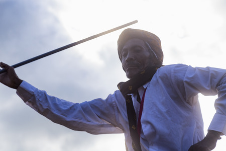 BAJAWA, INDONESIA - MAY 19: An unidentified man dances with a pole at a boxing match near  Bajawa in East Nusa Tenggara, Indonesia on May 19, 2017.のeditorial素材
