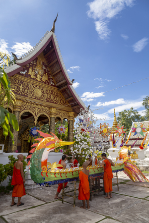LUANG PRABANG, LAOS - OCTOBER 4: Unidentified monks build a large naga float in the lead up to the end of Buddhist lent on October 4, 2017 in Luang Prabang, Laos.のeditorial素材