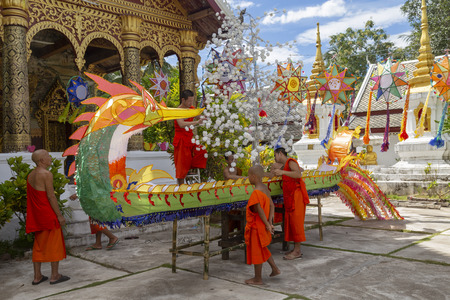 LUANG PRABANG, LAOS - OCTOBER 4: Closeup view of unidentified monks build a large naga float in the lead up to the end of Buddhist lent on October 4, 2017 in Luang Prabang, Laos.のeditorial素材