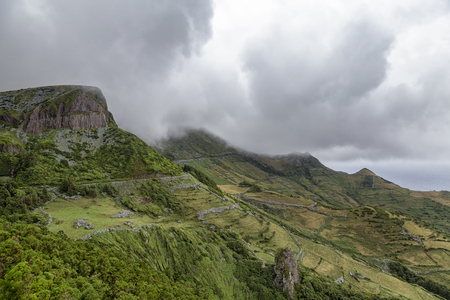 Summertime cloudy view of the Roches dos Bardoes basalt formation on Flores island in the Azores.の写真素材