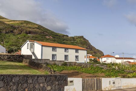 White painted houses from the street in Vila do Corvo on the island of Corvo in the Azores, Portugal.のeditorial素材