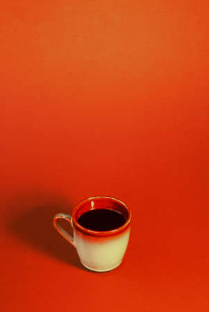 Cup of coffee on brown background with room for text.の写真素材