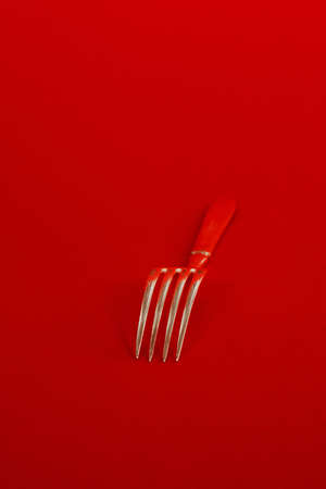 Fork on red backgroundの写真素材