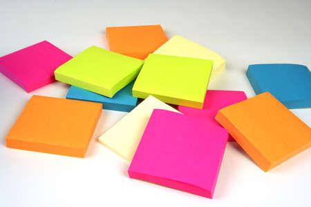 Colorful sticky notes in a pile on a white background