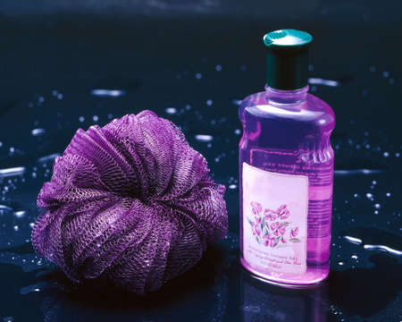 Body wash and scrub on black glass with water dropletsの写真素材