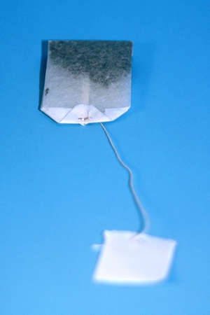  Tea bage laying flat with ticket in forgroundの写真素材