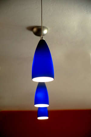  Three blue lights hanging from ceilingの写真素材