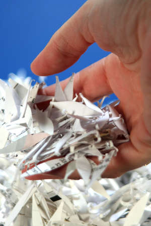 Hand holding shredded paperの写真素材