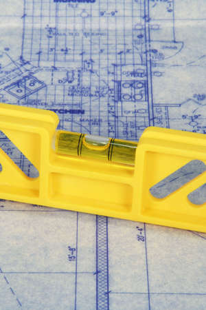 yellow level laying on blueprints
