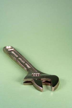 Adjustable wrench on a green backgroundの写真素材