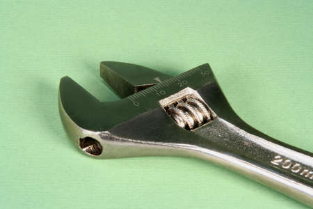  Top of an adjustable wrench on a green backgroundの写真素材
