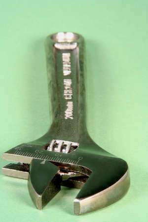 Adjustable wrench on a green backgroundの写真素材