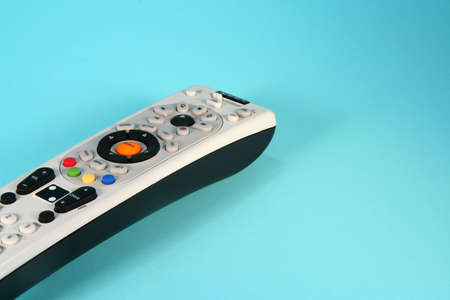 Colorful remote control on a light blue background