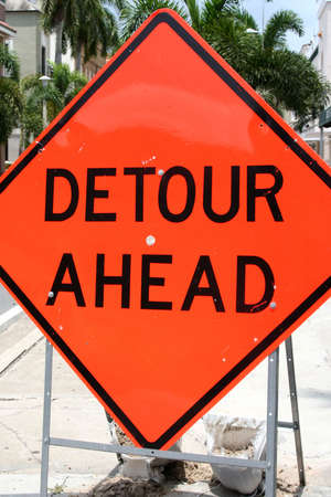 Orange detour sign in roadの写真素材