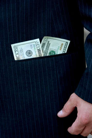 Closeup of money in pocket of man's suit