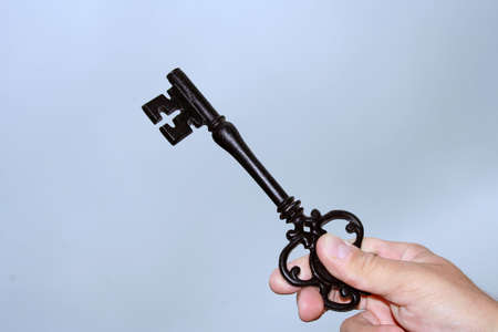 Black skeleton key against blue skyの写真素材