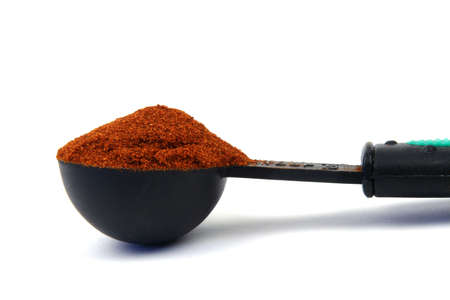 Red spice in a measuring spoonの写真素材