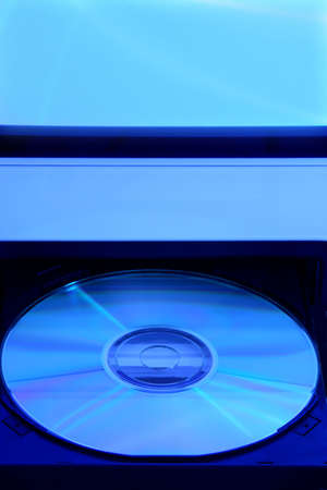 CD rom in open drive of compputer with a blue toneの写真素材