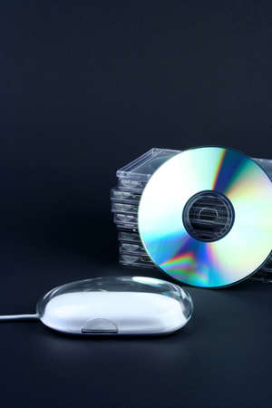 Cds and mouse on a black backgroundの写真素材