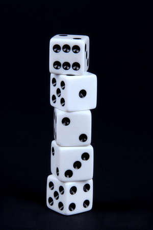 Five dice stacked together on a black background