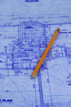 Pencil laying on a blueprint of house