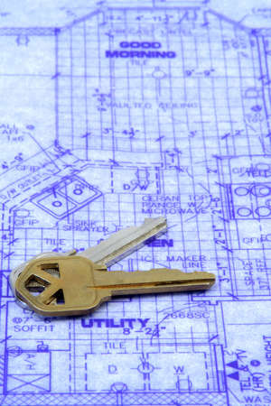 House keys laying over a blueprint of houseの写真素材