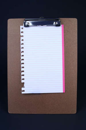 Spiral paper clamped on a clip board