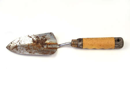 Garden shovel laying on a white backgroundの写真素材