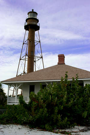 Old lighthouse next to an old houseの写真素材