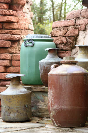 Colorful barrels sitting against a brick wallの写真素材