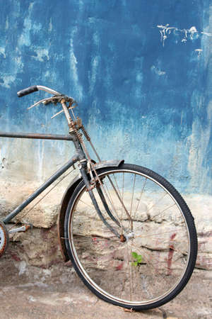 Front of bicycle against a blue wallの写真素材