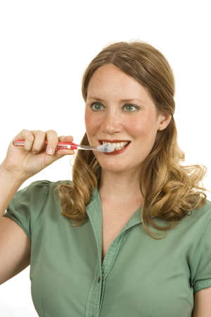 Young woman on white holding a toothbrush