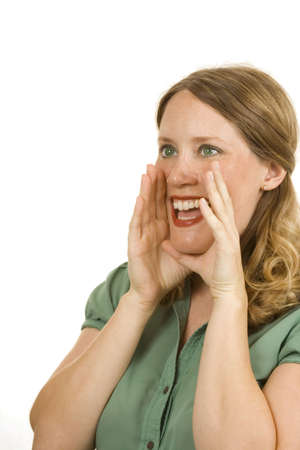 Young woman on white holding her hands to mouth shouting