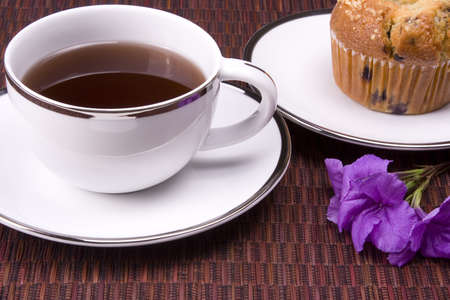 White coffee mug on place mat background with a muffin.の写真素材