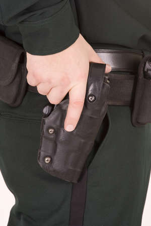 Close of of policeman's hand on his gun.の写真素材