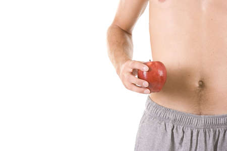 Young man on white eating an apple.の写真素材