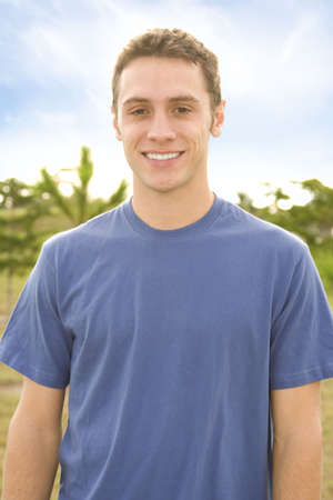 Young attractive casual man outside smiling into cameraの写真素材