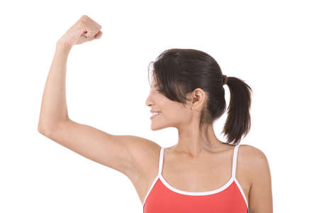 Young woman against a blue sky in a fitness pose